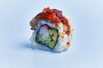 Fotobehang  SIngle uramaki sushi over blue background © Krakenimages.com