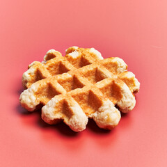  Single delicious waffle over red background