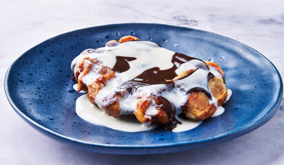  Plate of delicious waffle with chocolate and cream on marble surface