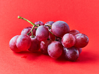  Bunch of grapes over red background