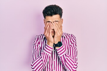 Young hispanic man wearing casual clothes rubbing eyes for fatigue and headache, sleepy and tired...