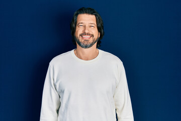 Obraz premium Middle age caucasian man wearing casual clothes with a happy and cool smile on face. lucky person.