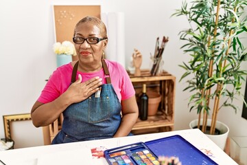 Senior african american woman communicating with deaf language at art studio