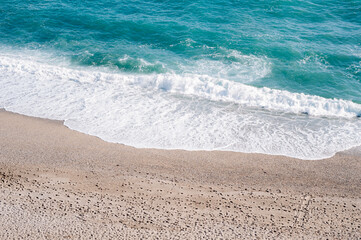 Beautiful beach, small grains of sand and blu waves