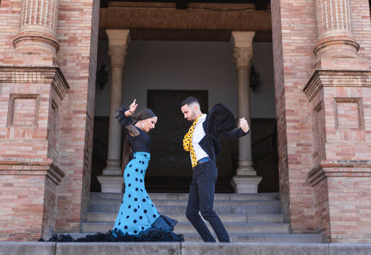 Two flamenco dancers performing in stairs of a building