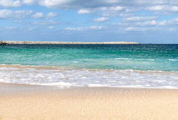 sandy seashore with blue water