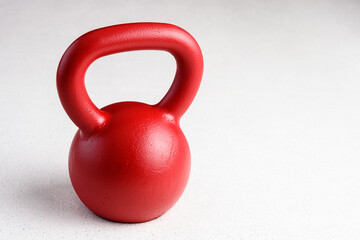 Fototapeta na wymiar Kettlebell winter fitness, red kettlebell on a white background with silver sparkles 