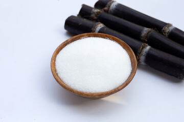 Sugar cane with sugar on white background