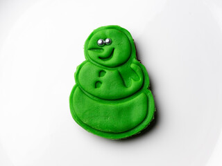 Cookie made with green sugar dough for kids with snowman figure
