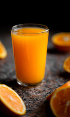 A Glass of Orange Juice with a Winter Black Background.