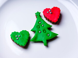 Cookie made with green sugar dough for kids with tree and heart figure