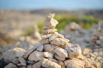 Cairn of stones in desert hills on Cyprus. Pyramid of rocks marking the trail for hiking.