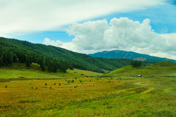 A view of grasslands and pastures taken through the windshield of a tour bus in Xinjiang, China