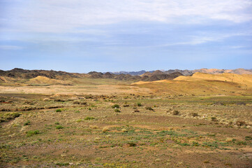 Fototapeta na wymiar The boundless natural scenery of the Gobi Desert grassland and pasture in Xinjiang, China