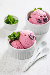 Cherry Vanilla Ice Cream or Cherry Frozen Yogurt on White Wooden Background. Selective focus.