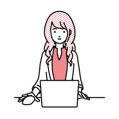 デスクで座ってPCを使っているジャケットの女性