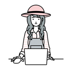 デスクで座ってPCを使っている農家の女性