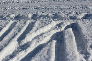 Fototapeta na wymiar Automobile tire tread marks on a snowy winter road