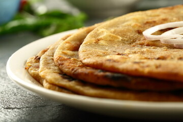 Indian vegetarian meal- healthy vegan diet - aloo paratha served with spicy potato curry and raita,.