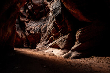 Bright Light Appears to Rush Around Dark Corner of Buckskin Gulch