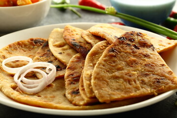 North Indian wholesome meal- traditional aloo paratha with fresh raita and potato curry.