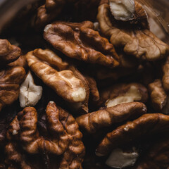 Heap of unshelled walnuts top view dark image full frame nuts macro