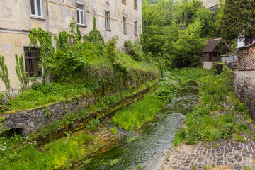 Fototapeta na wymiar Small stream in Idrija, Slovenia.