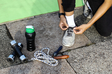 Person tying shoes getting ready for exercise workout routines