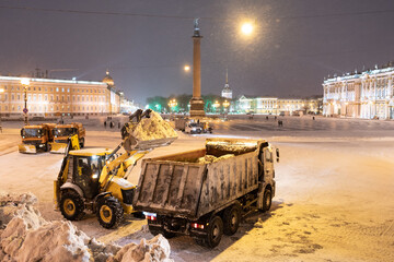 Snow removal equipment working at Palace Square at night after heavy snowfall. Snow cyclone or...
