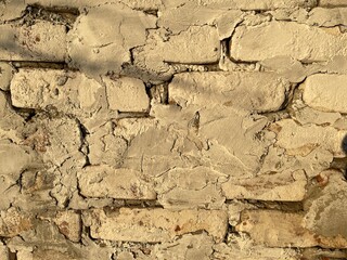 Texture of bricks with cement. Background texture of aged masonry. Rough wall of bricks. Close up. Concept of background for your text.