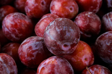 Close up of sweet red plum in box.