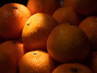 Tangerines. Ray of light shines on beautiful juicy tangerines