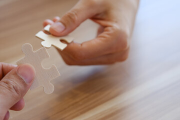 hand hold  jigsaw puzzle. Business  team support and help solutions, success and strategy concept.