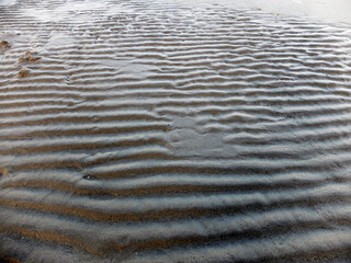 waves on sand. Texture of sand.