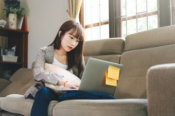 Obraz premium Young adult asian student woman learning at home indoor on day.