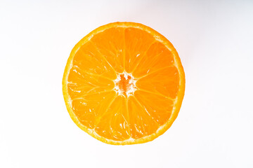 Close up of half orange colored  tangerine on white background
