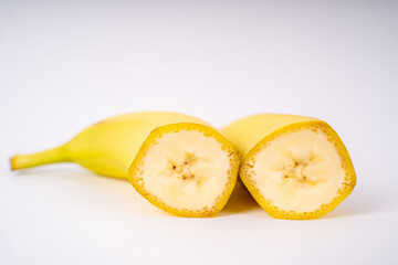 Two banana halves with white background