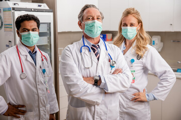A Professional Medical Team of Doctors. One Female Two Males with Generic ID Badges, Surgical...