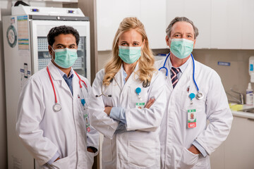 A Professional Medical Team of Doctors. One Female Two Males with Generic ID Badges, Surgical...