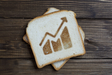 toast with the sign of a growing market on dark wood.