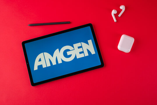 Tula, Russia - october 19, 2021: Amgen Inc displayed modern laptop on red background