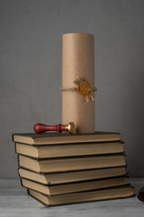 books, parchment scroll with seal and stamp on an old wooden table