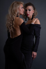 Fototapeta na wymiar Two young attractive women with problem skin faces posing in studio