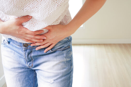 Stomach Pain Woman With White T Shirt And Jean Hold Hands On Her Body Suffering And Feeling Unwell 