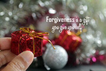 Forgiving inspirational quote - Forgiveness is a gift you give yourself. With person holding red...