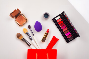 Professional makeup on a white background. Brushes, lipstick and other products, a flat lay with copy space