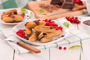 Mini churros with chocolate dipping sauce.