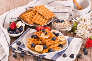 Waffles with blueberries, bananas and honey.