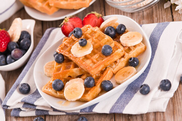 Waffles with blueberries, bananas and honey.