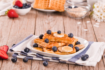 Waffles with blueberries, bananas and honey.